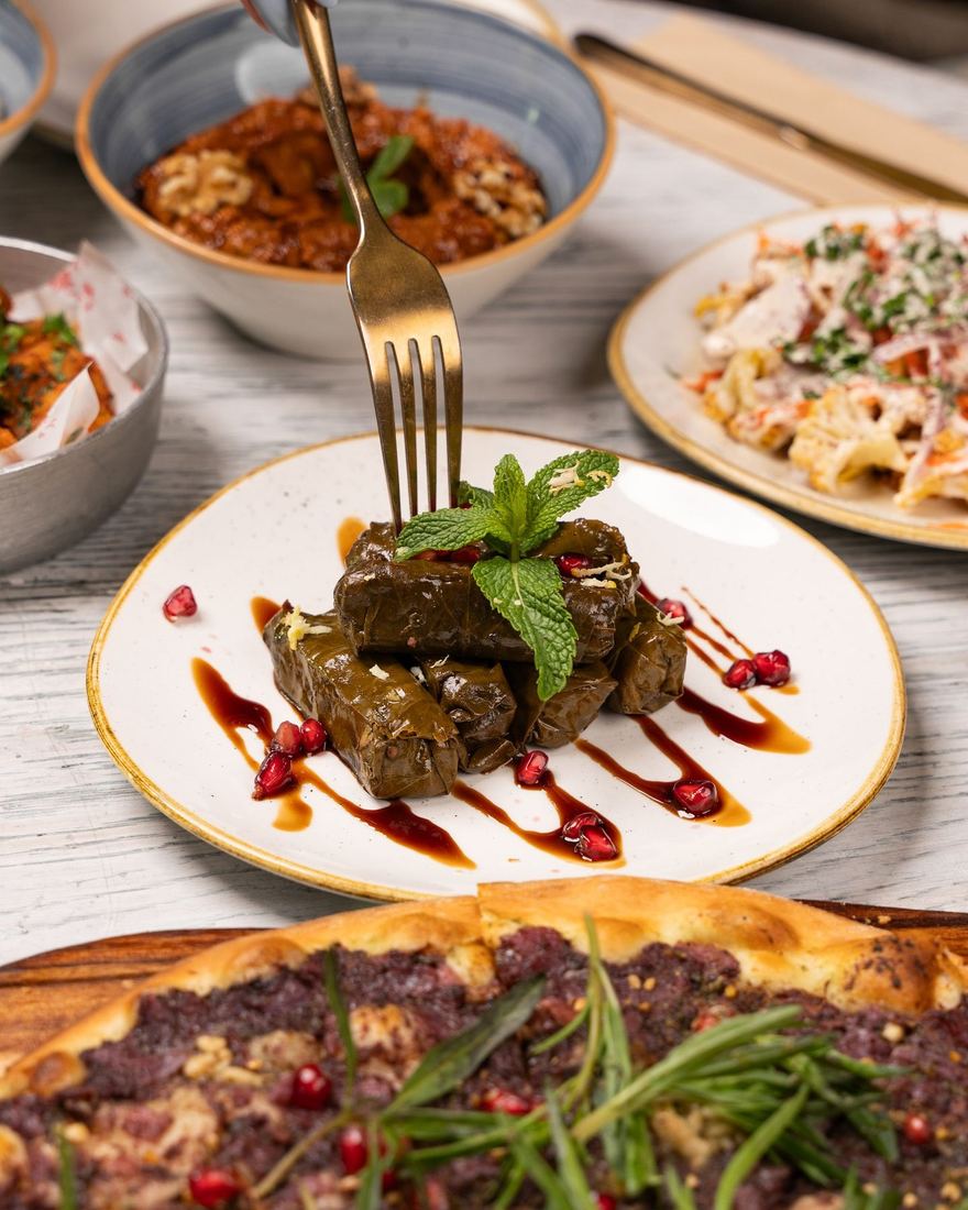 Stuffed vine leaves plated with herbs